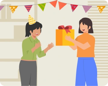 Two friends exchanging a birthday gift at a small celebration